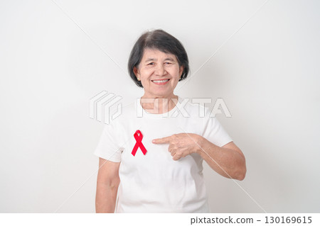 Elderly with Red Ribbon for December World Aids Day, MADD, October Red ribbon week, February Heart month, Marfan Syndrome, May Stroke awareness, March world TB Tuberculosis day and April Dare day 130169615