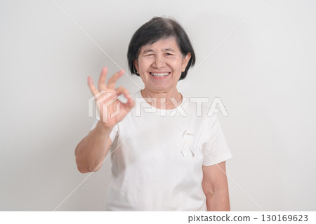 Elderly with White ribbon for concept November Lung Cancer Awareness month, Stop Violence Against Women, Adoption, May Retinoblastoma, Action for Women Health, March Remembrance, October Osteoporosis Elderly with White ribbon for concept November Lung Cancer Awareness month, Stop Violence Against Women, Adoption, May Retinoblastoma, Action for Women Health, March Remembrance, October Osteoporosis 130169623