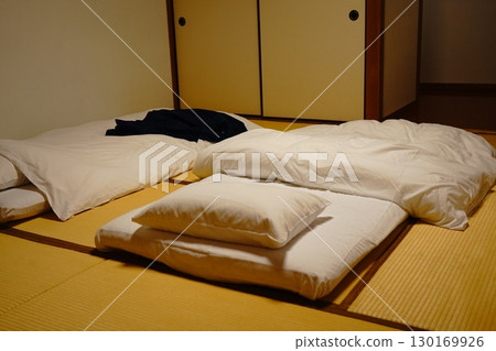 Japanese-style room with futon and pillows on tatami mats 130169926