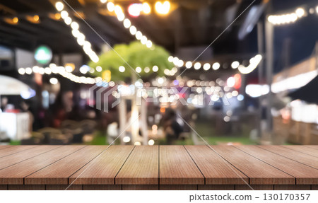 Empty wooden table top with lights bokeh on blur restaurant background. Empty wooden table top with lights bokeh on blur restaurant background. 130170357