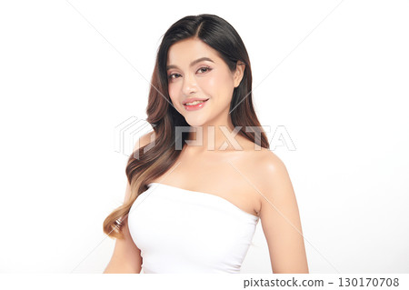 A beautiful young Asian woman with clean, fresh skin against a white background. Skincare, facial treatment, cosmetology, beauty, and spa. An elegant portrait of an Asian woman. 130170708