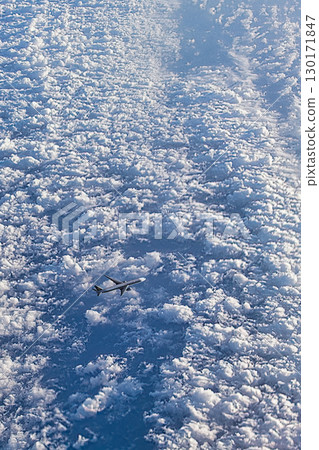 Jet plane flying through a sea of clouds 130171847