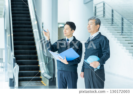 Businessmen in work clothes having a meeting at the site 130172003