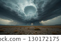 A dramatic storm gathers over a cracked and arid desert. 130172175