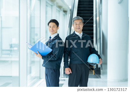 Businessmen in work clothes having a meeting at the site 130172317