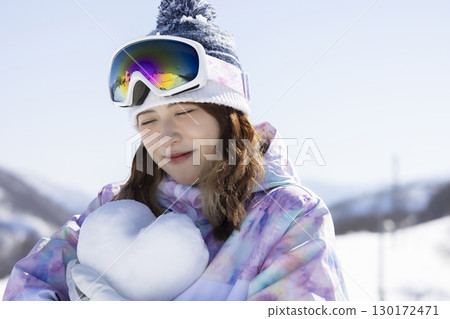 Cute woman enjoying the snowy mountains Cute woman enjoying the snowy mountains 130172471