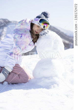 Cute woman enjoying the snowy mountains Cute woman enjoying the snowy mountains 130172472