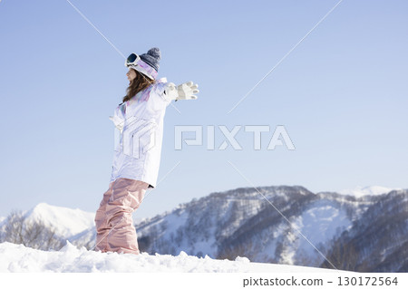 Cute woman enjoying the snow 130172564