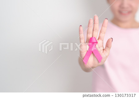 Pink October Breast Cancer Awareness month, woman with pink Ribbon for concepts of support people life and illness. National cancer survivors month, Women Health day and February World cancer day 130173317