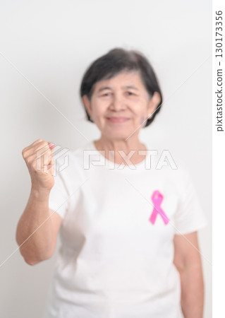 Elderly woman with pink Ribbon for Pink October Breast Cancer Awareness month, May Women Health, February World cancer day, support people life and illness. National cancer survivors month Elderly woman with pink Ribbon for Pink October Breast Cancer Awareness month, May Women Health, February World cancer day, support people life and illness. National cancer survivors month 130173356