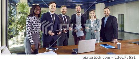 Portrait of diverse business people standing on a meeting and looking at the camera. Portrait of diverse business people standing on a meeting and looking at the camera. 130173651