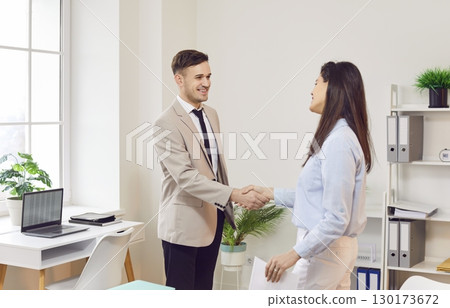 Smiling Businessman Shaking Hands With Colleague Or Client In Office 130173672