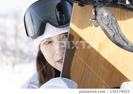 Cute woman enjoying snowboarding Cute woman enjoying snowboarding 130174025