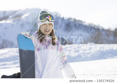 Cute woman enjoying snowboarding 130174026