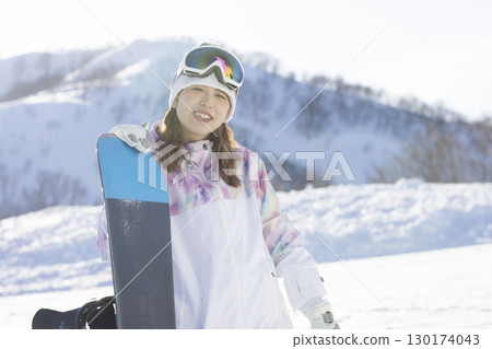Cute woman enjoying snowboarding Cute woman enjoying snowboarding 130174043