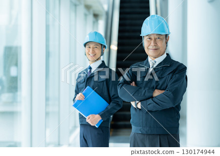 Businessmen in work clothes having a meeting at the site 130174944