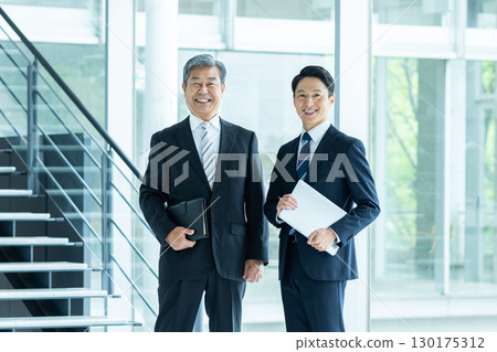 Business people walking down an office corridor 130175312