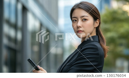 Businesswoman Using Smartphone in City Businesswoman Using Smartphone in City 130176034