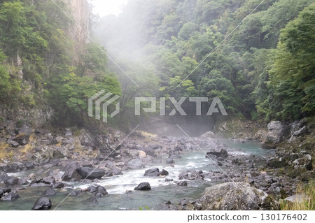 A hidden waterfall shrouded in mist A hidden waterfall shrouded in mist 130176402