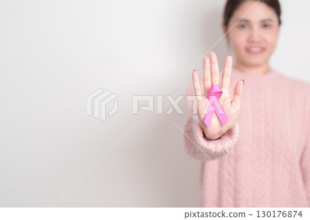 Pink October Breast Cancer Awareness month, woman with pink Ribbon for concepts of support people life and illness. National cancer survivors month, Women Health day and February World cancer day Pink October Breast Cancer Awareness month, woman with pink Ribbon for concepts of support people life and illness. National cancer survivors month, Women Health day and February World cancer day 130176874