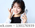 Image of a woman listening to music on a smartphone 130176939