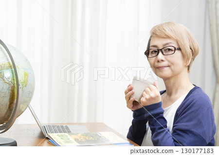 Senior woman looking forward to planning a trip 130177183