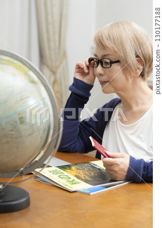 Senior woman looking forward to planning a trip 130177188