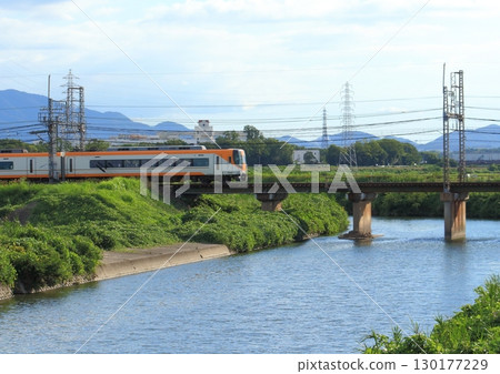 A Kintetsu limited express train on the Kintetsu Kashihara Line passes over a railway bridge over the Saho River 130177229