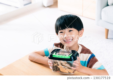 A boy observing a stag beetle 130177519