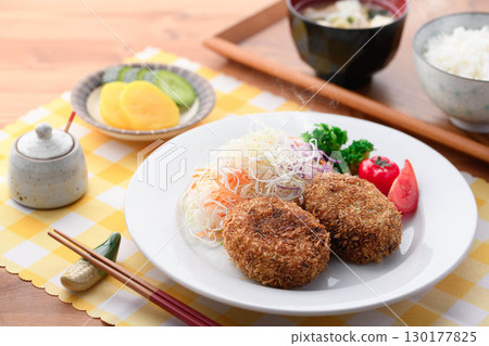 Steaming freshly fried croquette set meal with shredded cabbage, rice, miso soup and pickles for a Japanese lunch Steaming freshly fried croquette set meal with shredded cabbage, rice, miso soup and pickles for a Japanese lunch 130177825