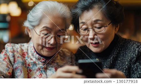 Two Senior Women Using Smartphone Together Two Senior Women Using Smartphone Together 130177918