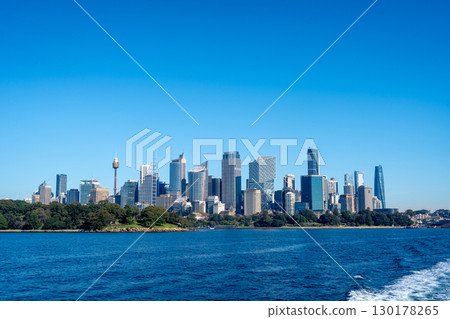 Sydney skyline view with skyscrapers and blue sky from the water Sydney skyline view with skyscrapers and blue sky from the water 130178265