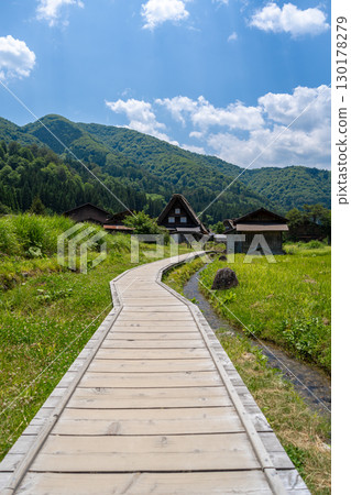 Wooden path crossing traditional village of Shirakawa-go in Japan Wooden path crossing traditional village of Shirakawa-go in Japan 130178279