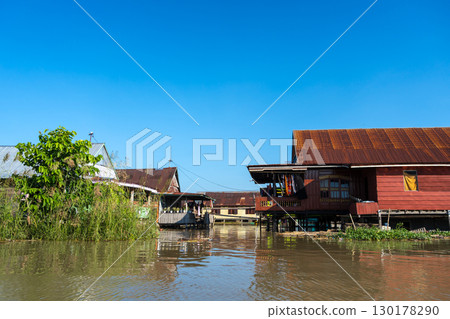 Houses on Lake Tempe, Sulawesi, Indonesia at sunrise Houses on Lake Tempe, Sulawesi, Indonesia at sunrise 130178290