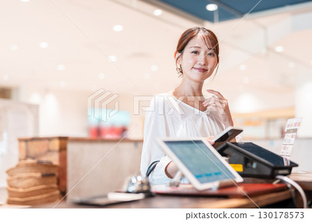 Cashless smartphone payment young woman Cashless smartphone payment young woman 130178573