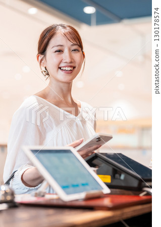 Cashless smartphone payment young woman 130178574