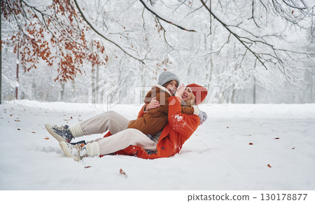 Embracing each other. Mother and her daughter is on the winter meadow and forest Embracing each other. Mother and her daughter is on the winter meadow and forest 130178877