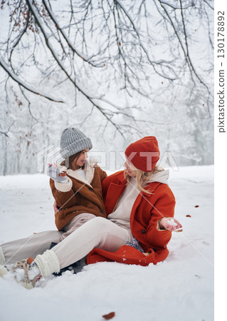 On the snow. Mother and her daughter is on the winter meadow and forest On the snow. Mother and her daughter is on the winter meadow and forest 130178892