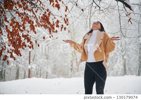 Happy woman is in the winter forest Happy woman is in the winter forest 130179074