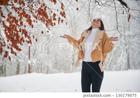 Happy woman is in the winter forest Happy woman is in the winter forest 130179075
