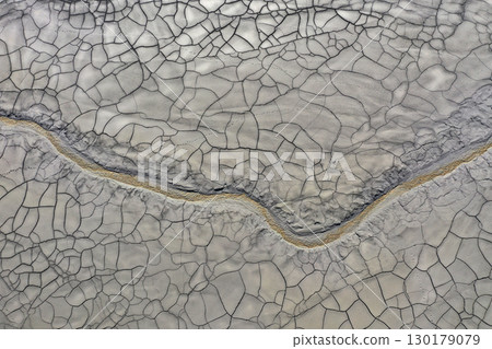 Aerial view of gray abstract mud patterns and cracks on acid mine drainage surface Aerial view of gray abstract mud patterns and cracks on acid mine drainage surface 130179079