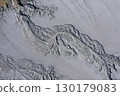 Aerial view of gray abstract mud patterns and cracks on acid mine drainage surface 130179083