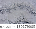 Aerial view of gray abstract mud patterns and cracks on acid mine drainage surface 130179085