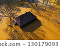 Aerial view of sinking village house in the middle of toxic mine decanting lake 130179093