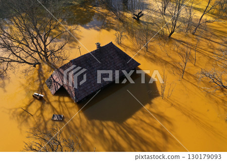Aerial view of sinking village house in the middle of toxic mine decanting lake Aerial view of sinking village house in the middle of toxic mine decanting lake 130179093