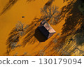 Aerial view of sinking village house in the middle of toxic mine decanting lake 130179094