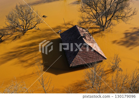 Aerial view of sinking village house in the middle of toxic acid mine drainage decanting pond. Geamana, Rosia Montana, Romania Aerial view of sinking village house in the middle of toxic acid mine drainage decanting pond. Geamana, Rosia Montana, Romania 130179096
