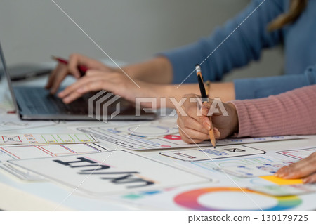 Hands on UX and UI design process with sketches and laptop 130179725