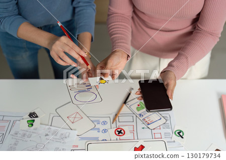 UX and UI Design Ideation. Designers creating user interface concepts with sketches. 130179734