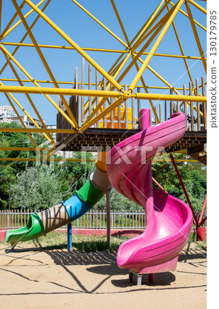 Colorful playground with slides and climbing structure 130179785
